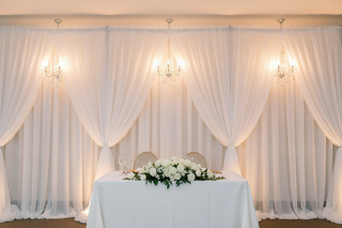 indoor wedding reception with Sheer Voile Flame Retardant (FR) 10ft H x 118" W Drape/Backdrop Curtain Panel - White