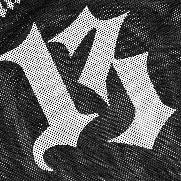 Close-up of black mesh football jersey with bold white gothic skull emblem print
