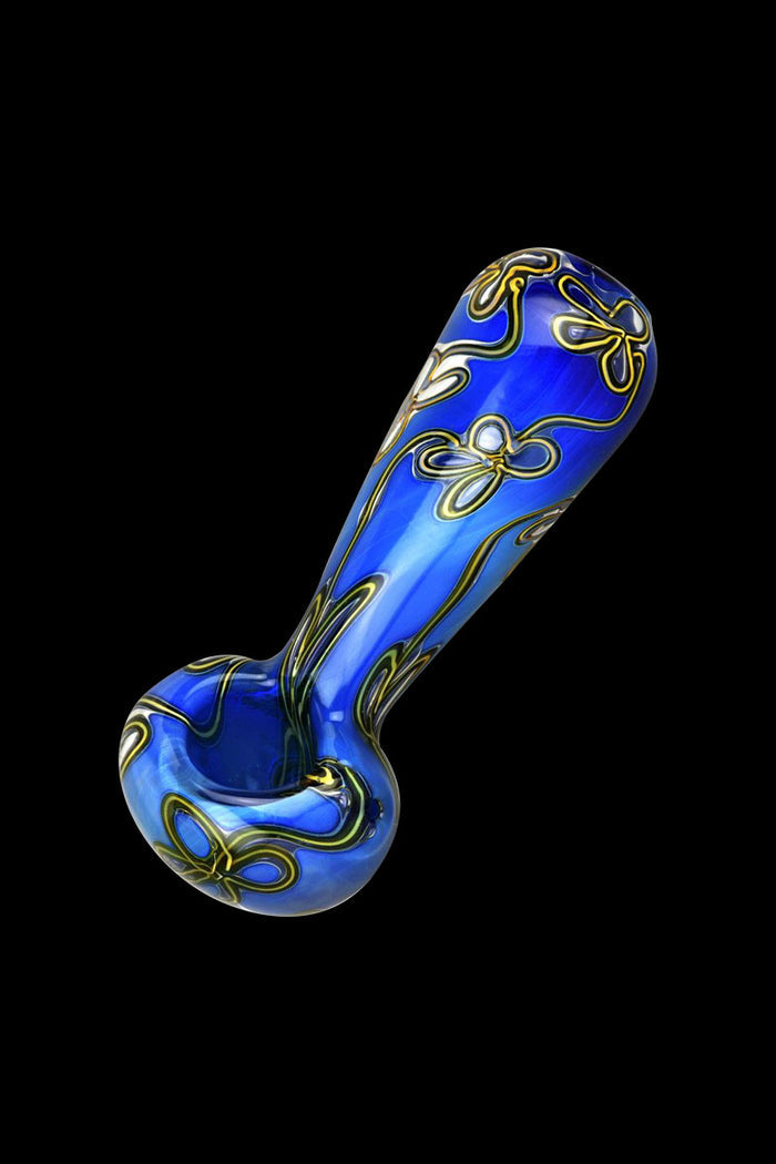 A side view of the Trippy Floral Double Glass Spoon Pipe, showcasing its colorful floral pattern on clear glass.