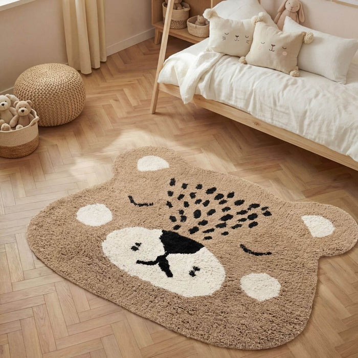 Children's room with a bear-shaped rug on a wooden floor.