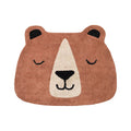 Bear-shaped rug with a smiling face on a white background