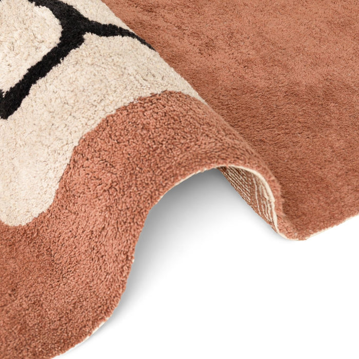 Close-up of a textured rug with geometric pattern on a white background