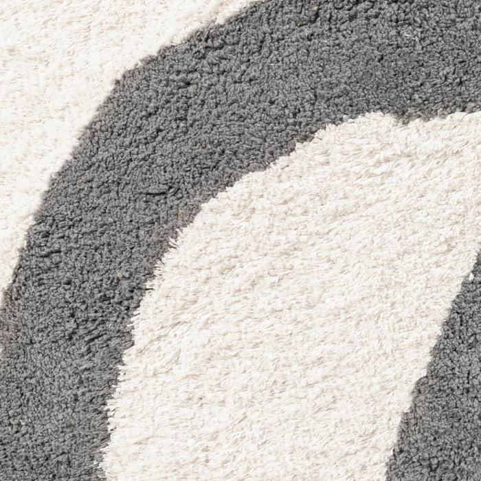 Close-up of a textured rug with gray and white colors.