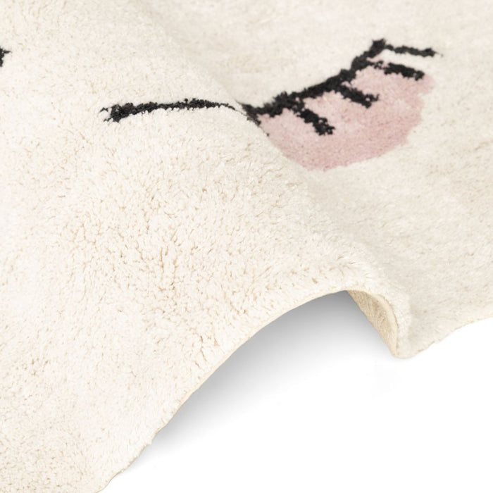 Close-up of a textured rug with a heart design on a light background