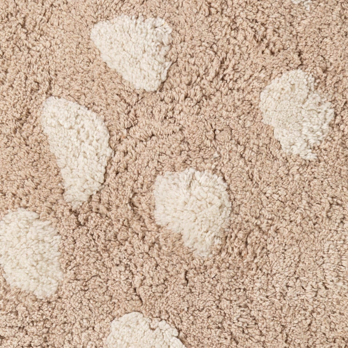 Close-up of textured beige carpet with raised patterns