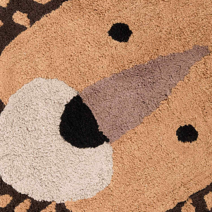 Close-up of a textured doormat with a bear design.