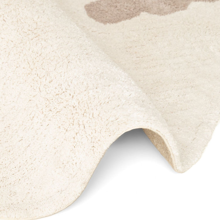 Close-up of a textured beige rug with a soft, plush surface.