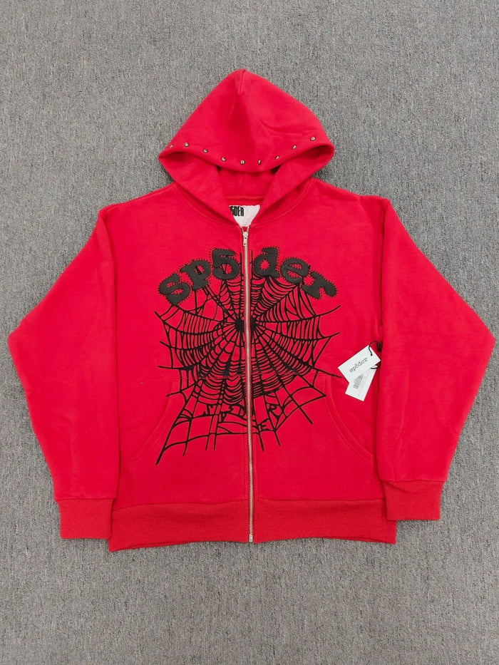 Red Sp5der zip-up hoodie with black spiderweb graphic and studded hood trim laid flat
