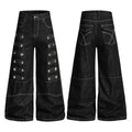 Black wide-leg denim jeans with pyramid metal studs and layered strap panels, front and back view on white background