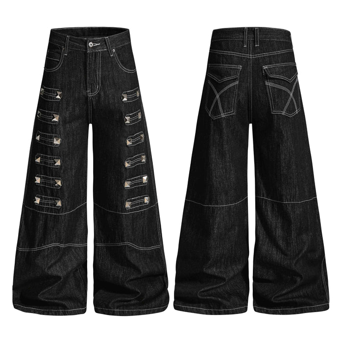 Black wide-leg denim jeans with pyramid metal studs and layered strap panels, front and back view on white background
