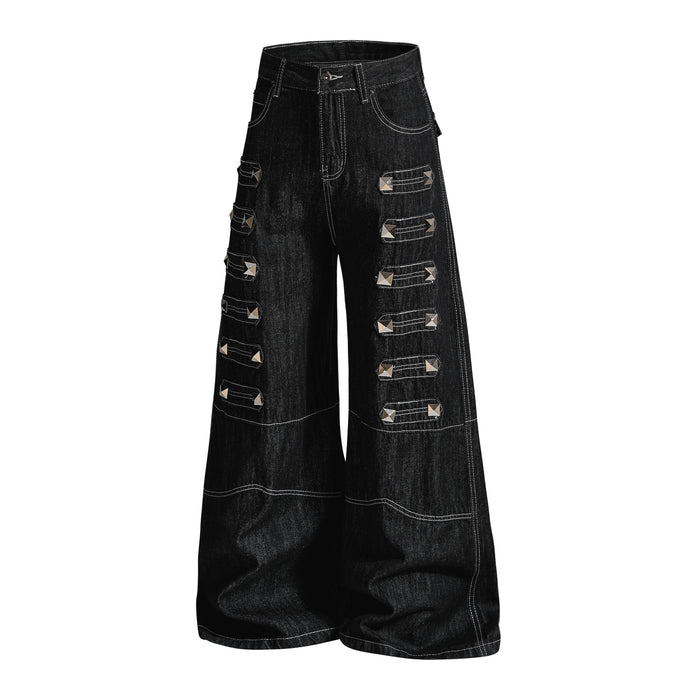 Black wide-leg denim pants with studded strap accents, angled front view