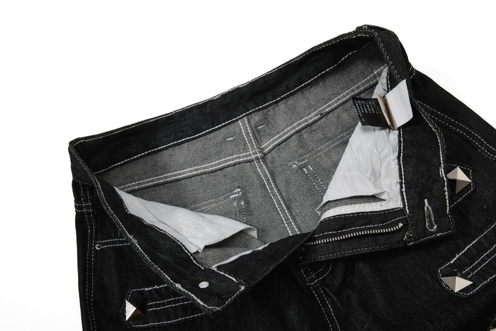 Inside view of black denim waistband and pocket lining with care tags