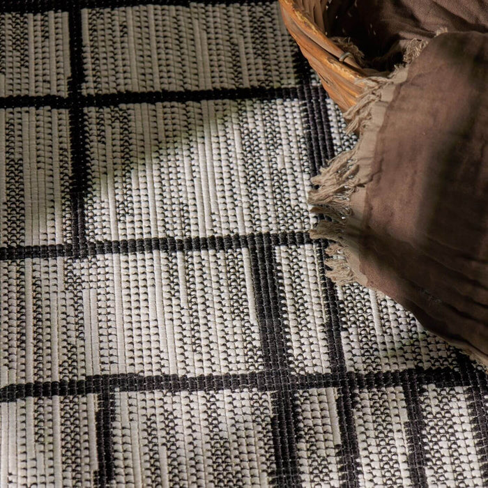 Close-up of a woven rug with a basket on top