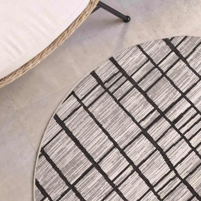 Round geometric patterned rug on a tiled floor