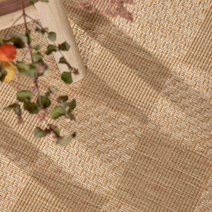 Textured beige fabric with a vase and floral arrangement on a wooden surface
