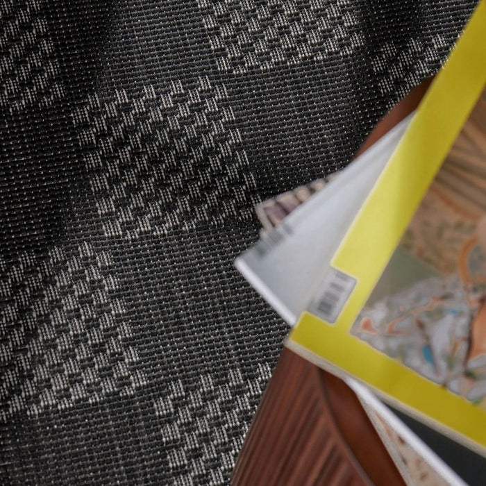 Close-up of a book with a colorful cover on a textured black surface