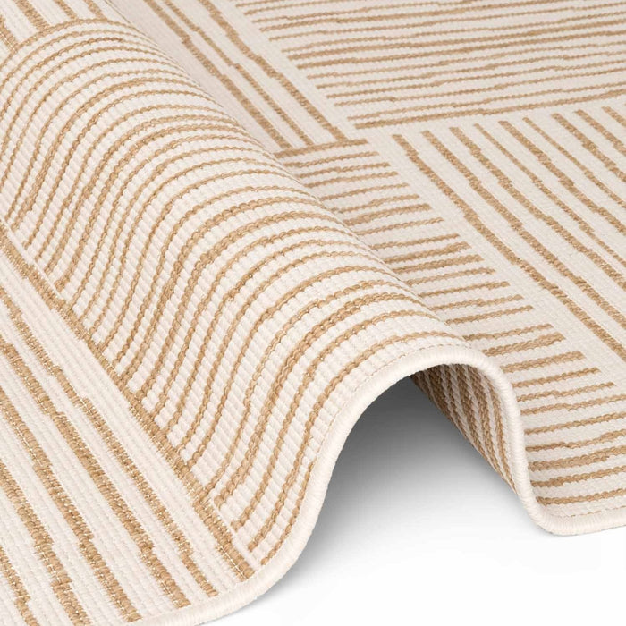Close-up of a textured beige and white rug with diagonal stripes.