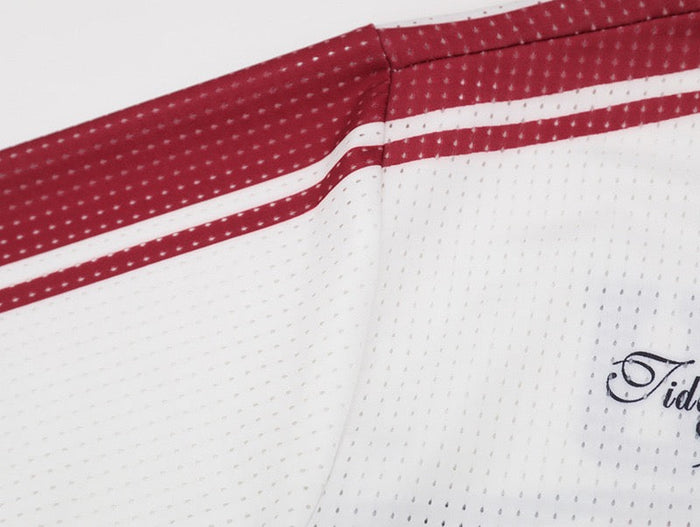 White mesh football jersey with red striped shoulder panels and small Tideeku logo detail