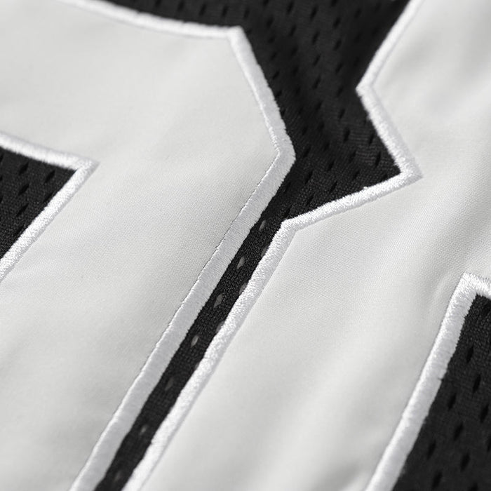 Close-up of black mesh football jersey with white stitched number 68 on a varsity-style sports tee