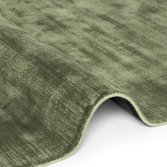 Close-up of a green textured rug on a white background