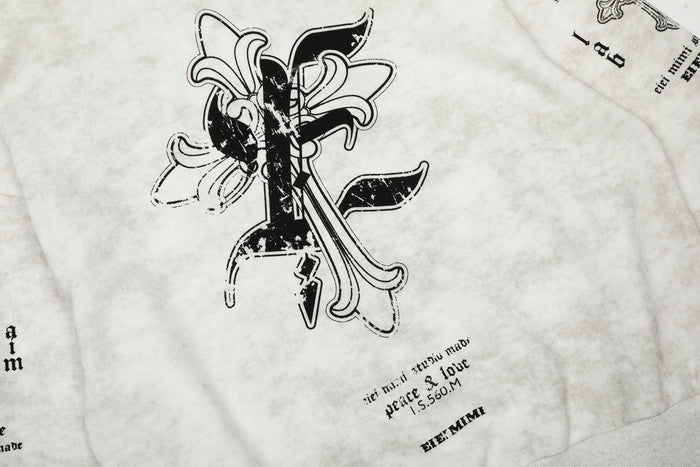 Close-up of front chest graphic on white hoodie with black gothic lettering and cross design
