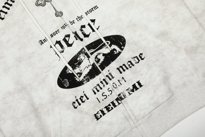 Close-up of front pocket area showing black oval graphic, lettering, and white drawstrings