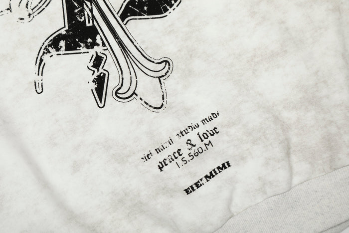 Close-up of lower front print on white hoodie with gothic text and ribbed hem