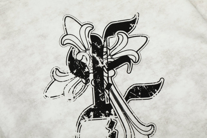 Close-up of back graphic on white hoodie with layered black cross and floral-style design