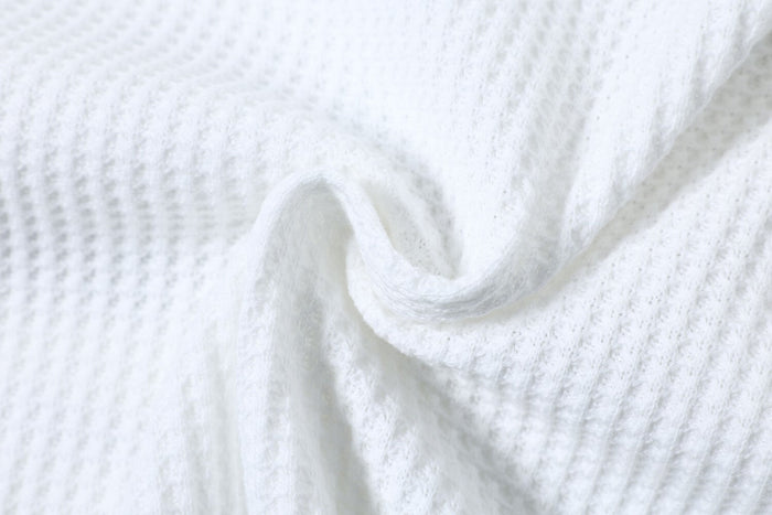 Close-up of gathered white waffle knit fabric texture