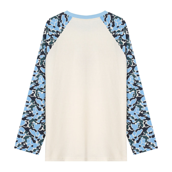 Front view of cream raglan long sleeve tee with blue camo sleeves and light blue ribbed crew neck