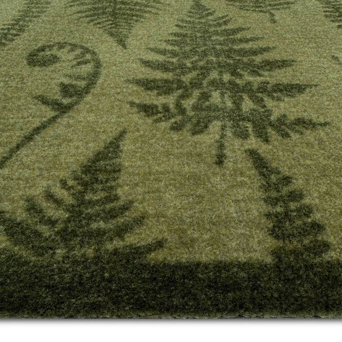 Close-up of a green textured fabric with tree patterns