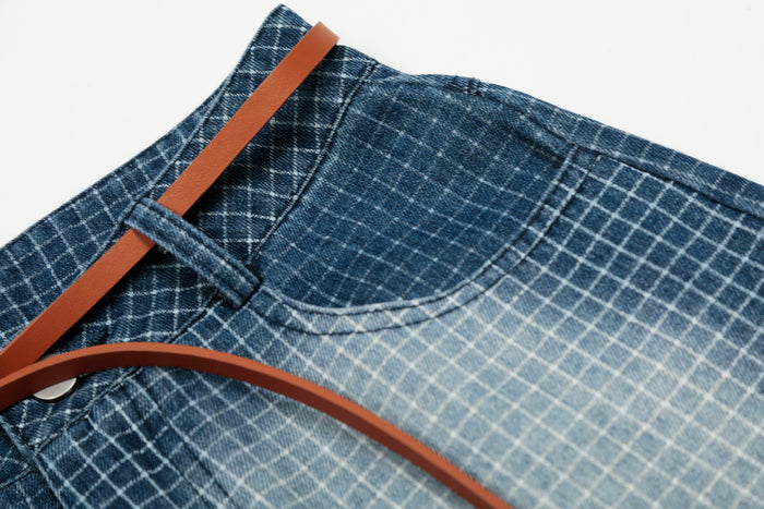 Close-up of back waistband and pocket on blue grid denim shorts with belt