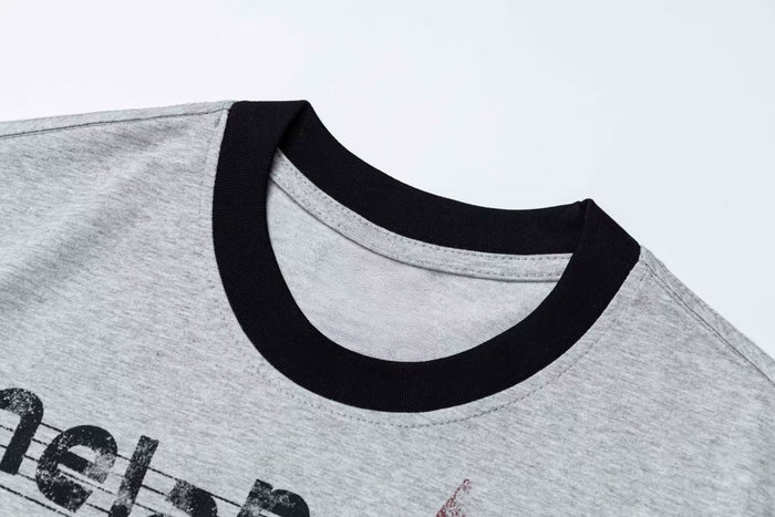 Heather gray ringer T-shirt with black collar and vintage music sheet graphic detail on the chest