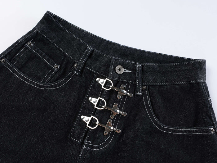 Close-up of the front waistband and triple buckle closures on dark wash denim shorts