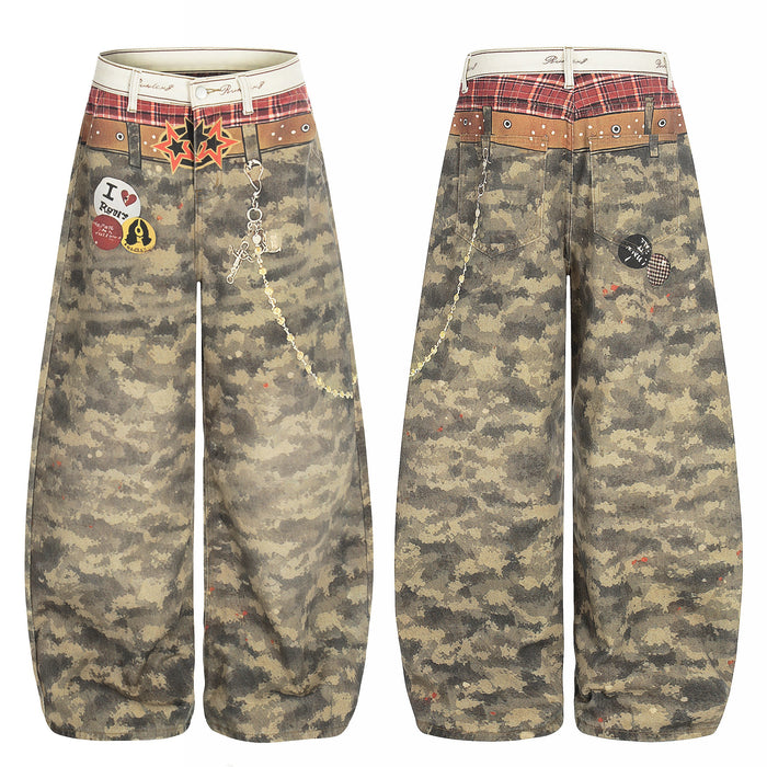 Front and back view of wide-leg camo denim pants with printed plaid waistband, star graphics, badge patches, and decorative c