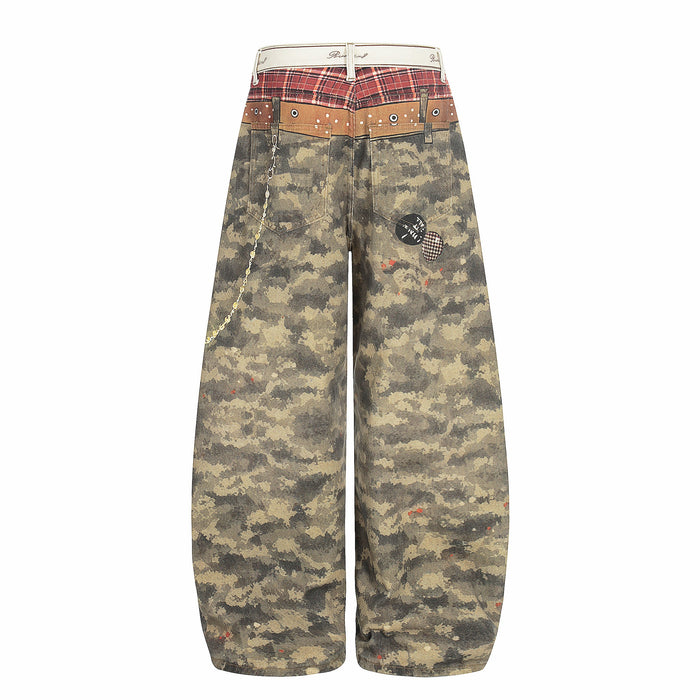 Back view of wide-leg camo patchwork denim pants with plaid yoke and chain detail