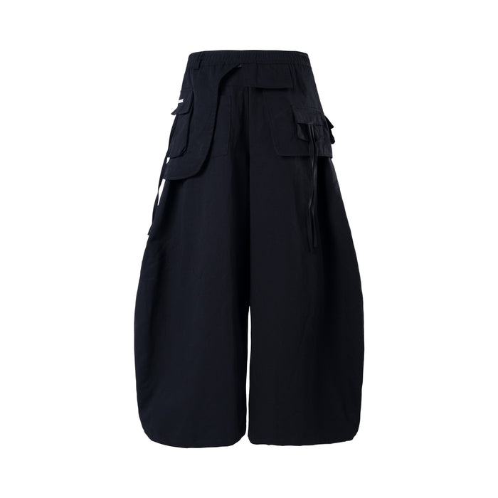 Black wide-leg cargo pants back view with layered cargo pockets and elastic waistband