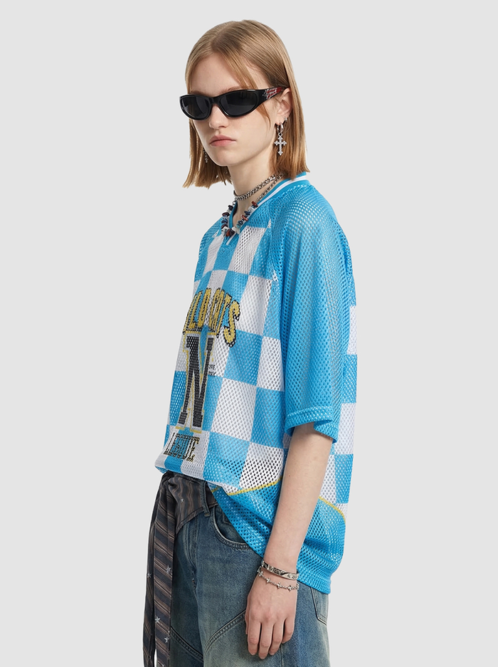 Model wearing a blue and white checkerboard mesh jersey T-shirt with Wildcats N League graphic and oversized fit