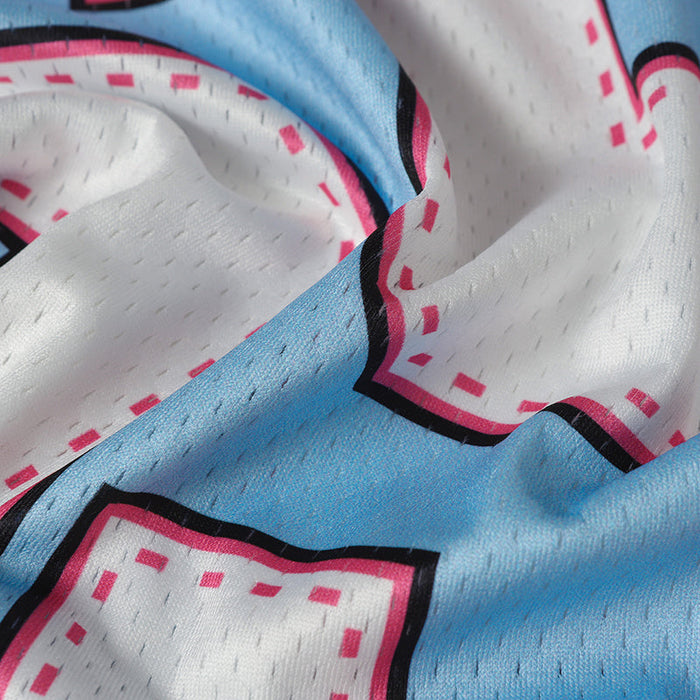 Close-up of baby blue and white mesh football jersey fabric with pink and black graphic trim